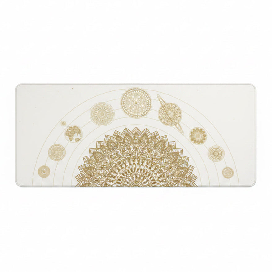 Desk setup with a decorative mouse pad featuring gold mandala designs on a black surface.